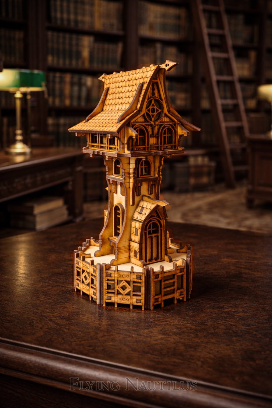 Dark fairy tower created by Flying Nautilus sits on an oak table in the library